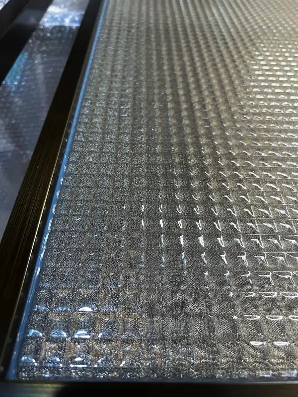 Angled view of Black Framed Reeded Glass stainless steel Screen