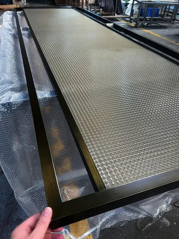 Close detail of Black Framed Reeded Glass stainless steel Screen