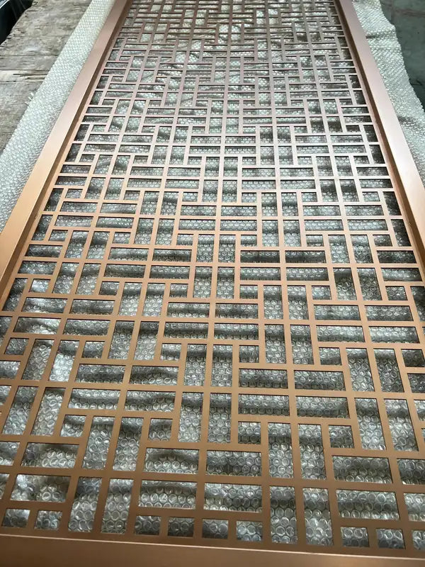 Angled view of Bronze Grid Floral stainless steel Screen Panels
