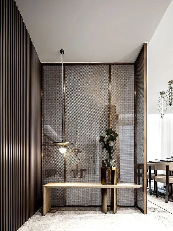 Bronze mesh metal screen partition at an interior entry