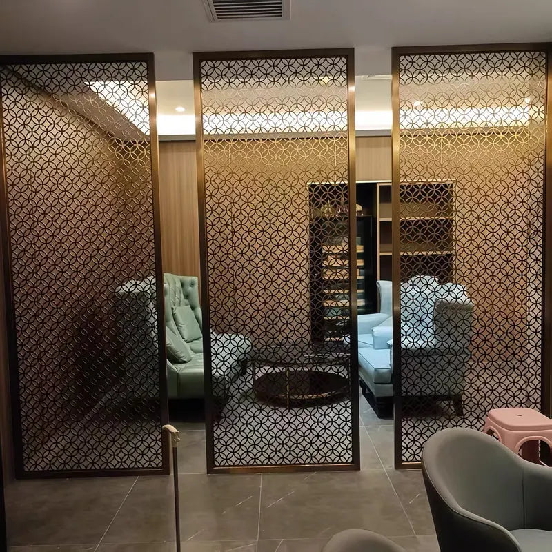 Bronze stainless steel lattice screen walls dividing a hotel-style lobby