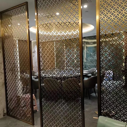 Bronze stainless steel lattice screen beside a hotel lounge