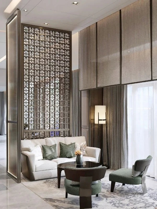Decorative bronze metal screen partition behind a bedroom seating area