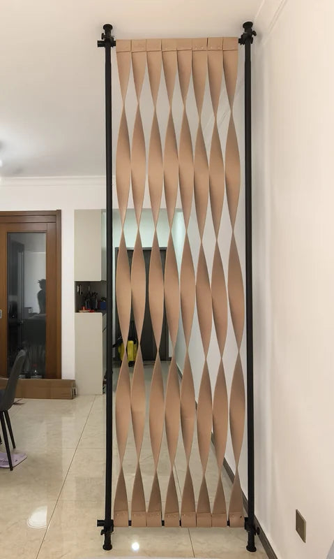 Gold-toned expandable stainless steel screen divider in a residential hallway