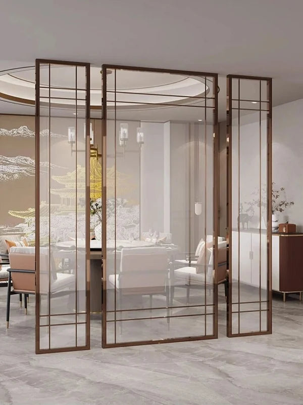 Framed glass and metal folding screen divider in an interior