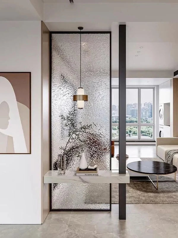 Textured glass stainless steel divider separating a living room from an entry