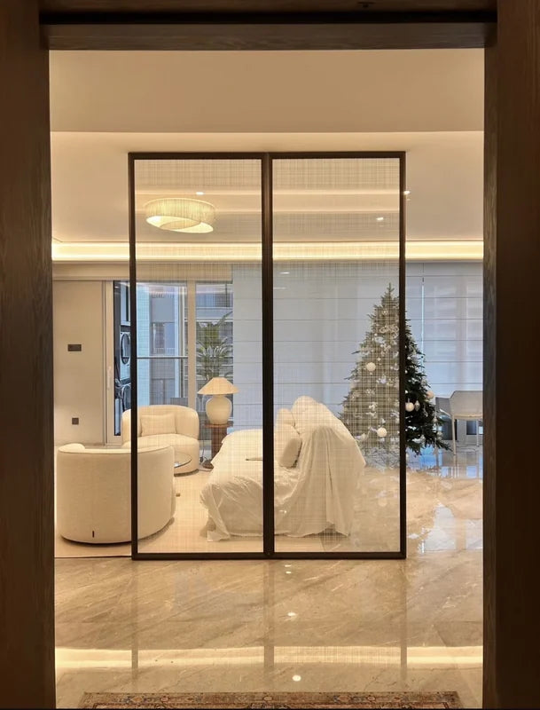 Slim black stainless steel glass screen separating a living room entrance
