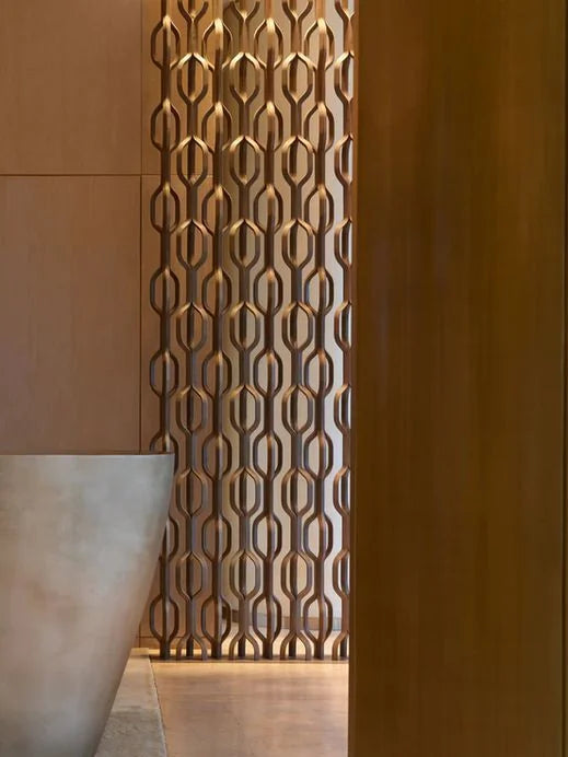 Close-up of a gold geometric metal screen partition