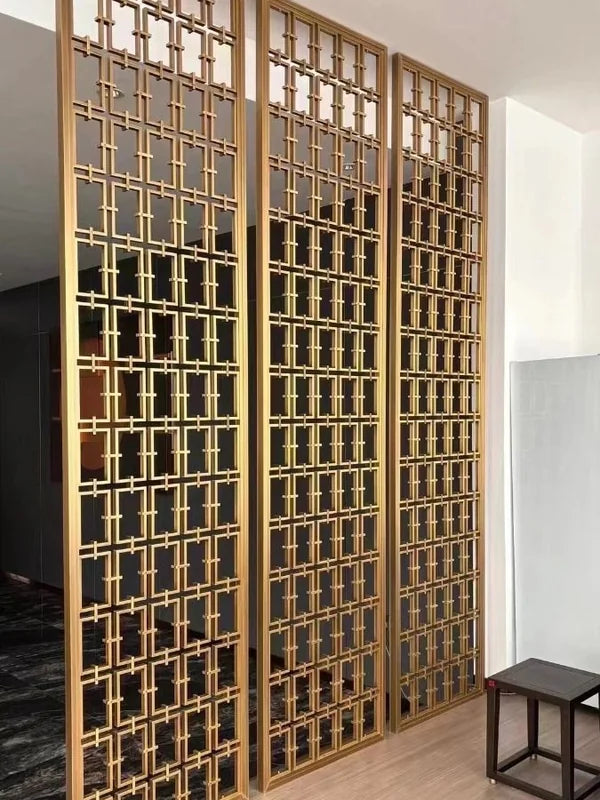Gold laser cut metal screen partition in a residential interior