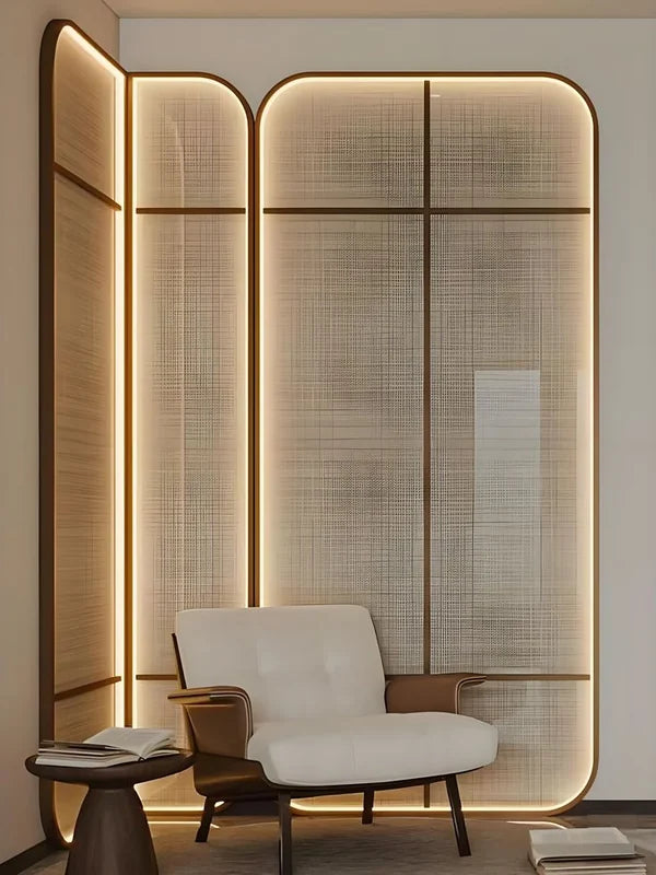 Illuminated bronze metal mesh screen with glass panels in a lounge