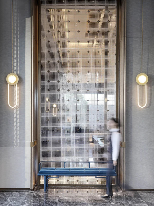 Patterned metal screen partition in a hotel-style lobby
