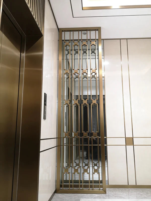 Gold-toned geometric stainless steel screen in an interior corridor