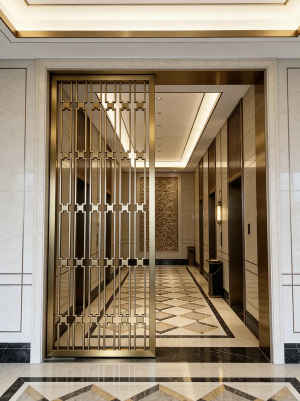 Decorative stainless steel geometric screen across a hotel-style passage