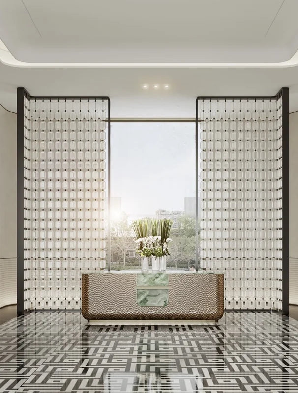 Tall stainless steel grid screens framing a bright interior passage