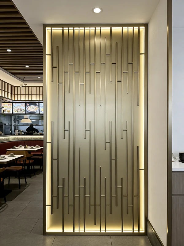 Champagne-toned stainless steel grille screen beside a dining area