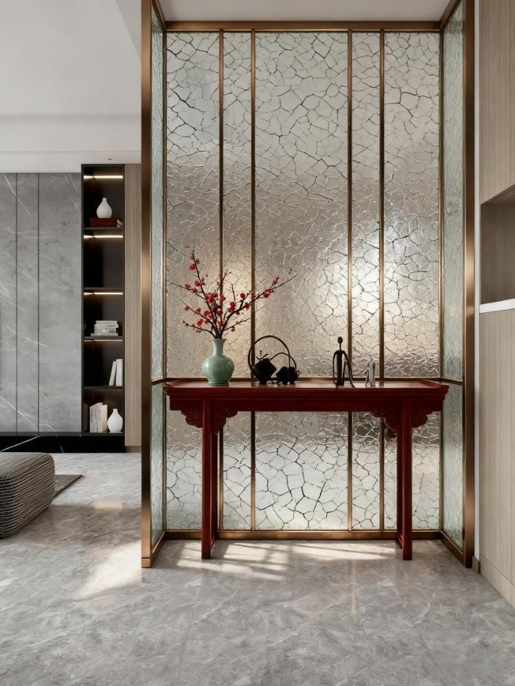 Bronze-toned stainless steel framed screen with crackle-textured translucent panels in a living room.