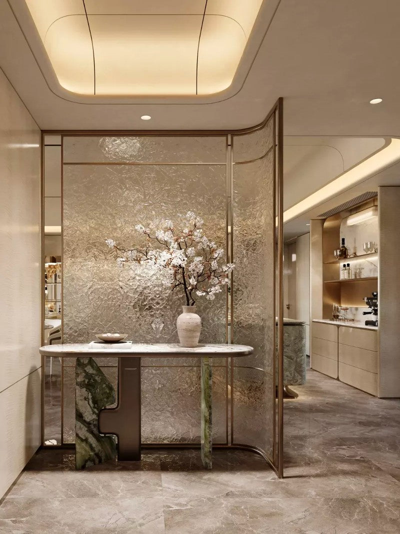 Bronze-toned stainless steel screen with curved framed sections and textured translucent panels.