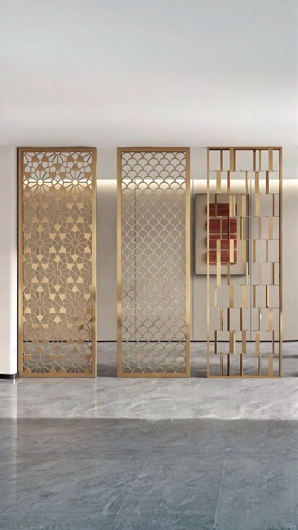 Three framed decorative stainless steel screen panels with floral, scalloped and open geometric patterns.