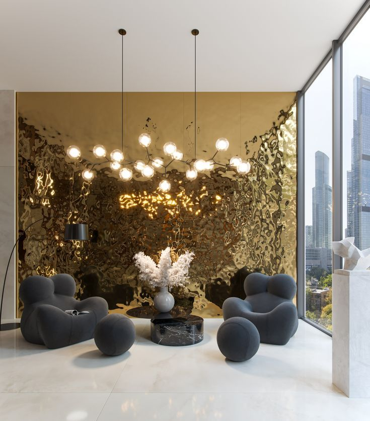 Gold-toned water ripple stainless steel wall panels behind a lounge seating area.