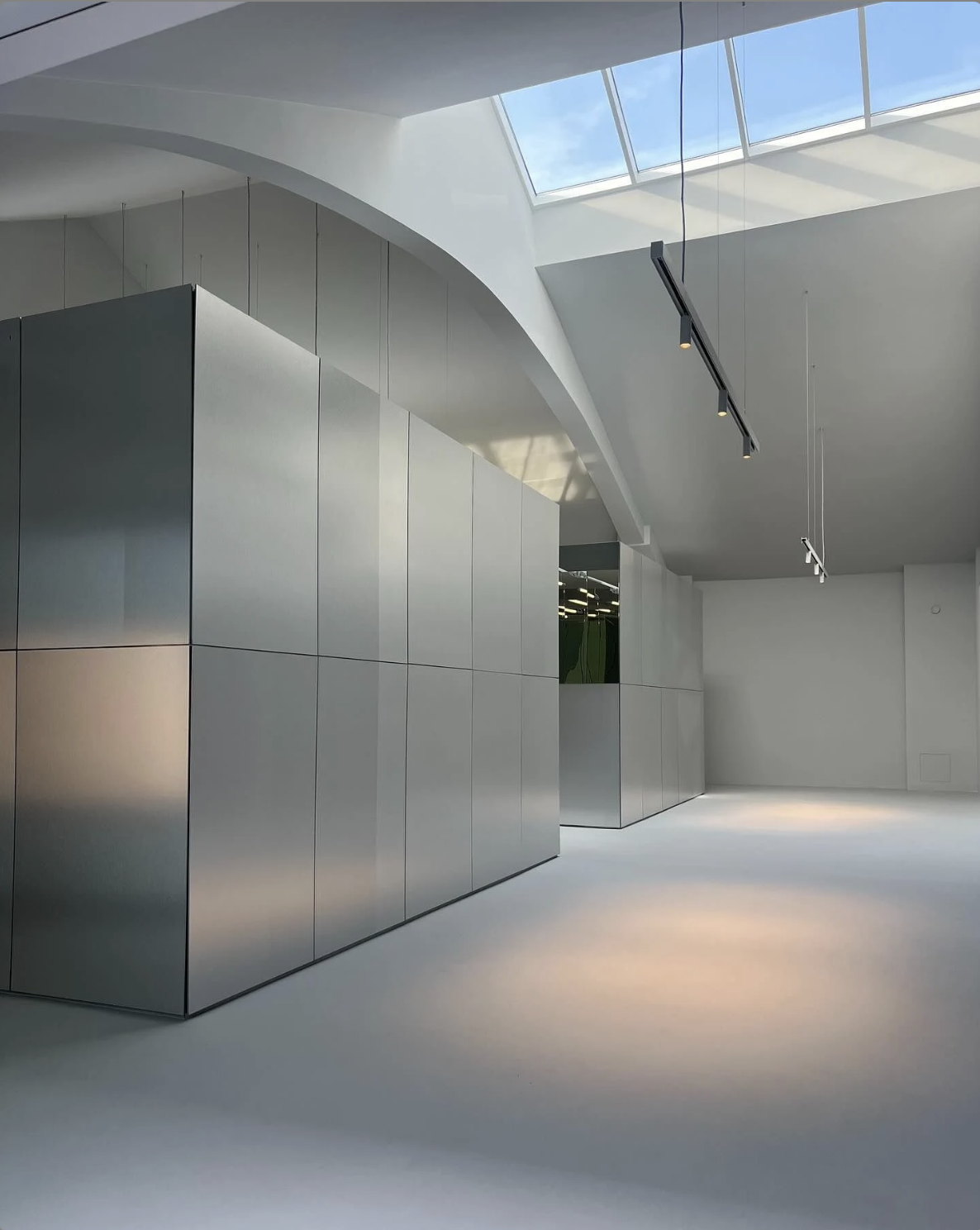 Silver smooth stainless steel wall panels forming a clean interior partitioned wall.