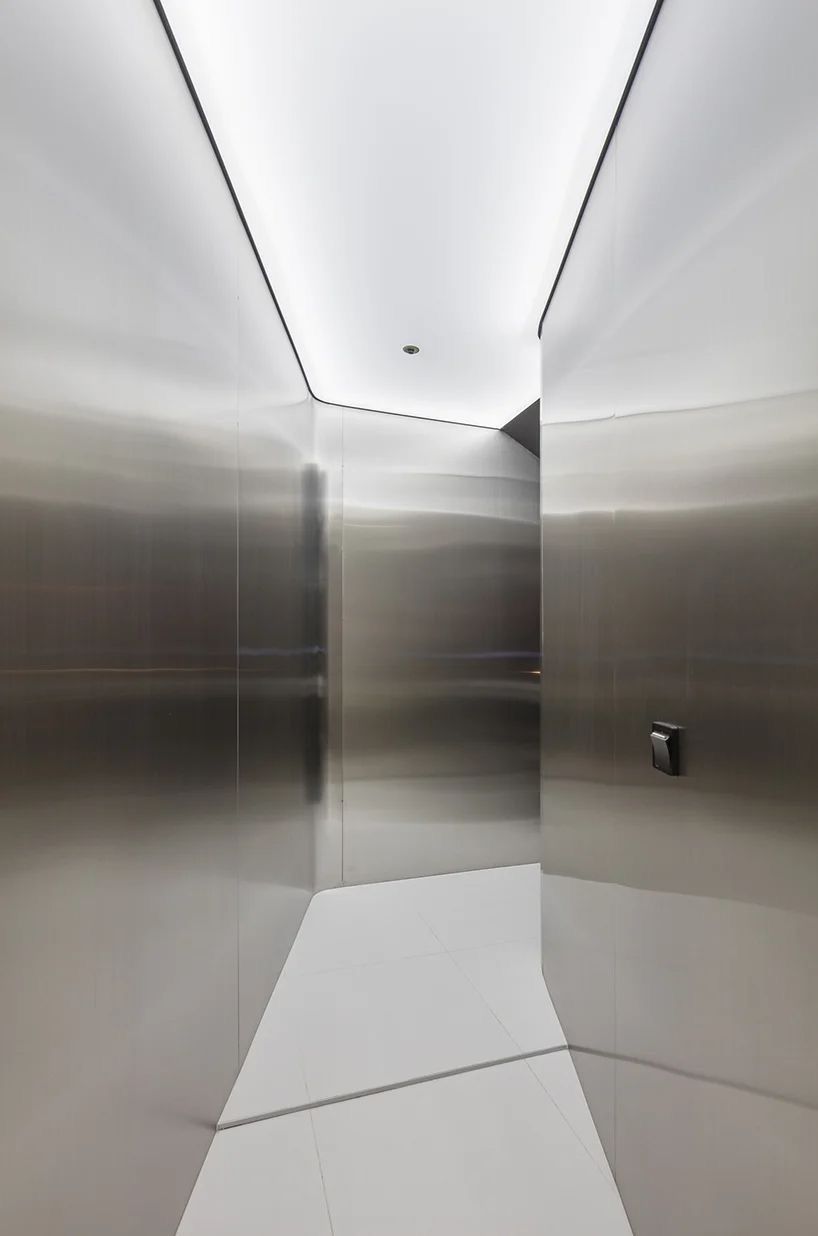 Silver stainless steel wall panels lining a compact interior space.